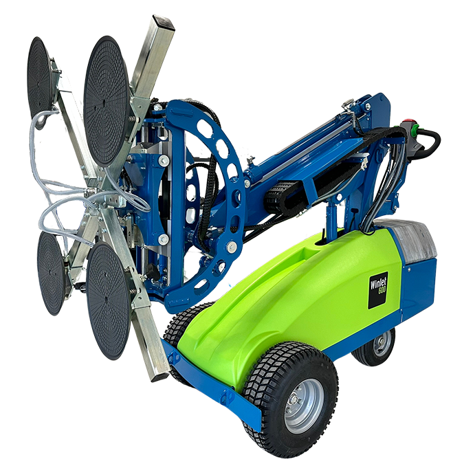 Winlet 600 glazing robot featuring a blue and bright green body, rugged tires, and an extendable hydraulic arm equipped with four large vacuum suction cups for lifting glass.